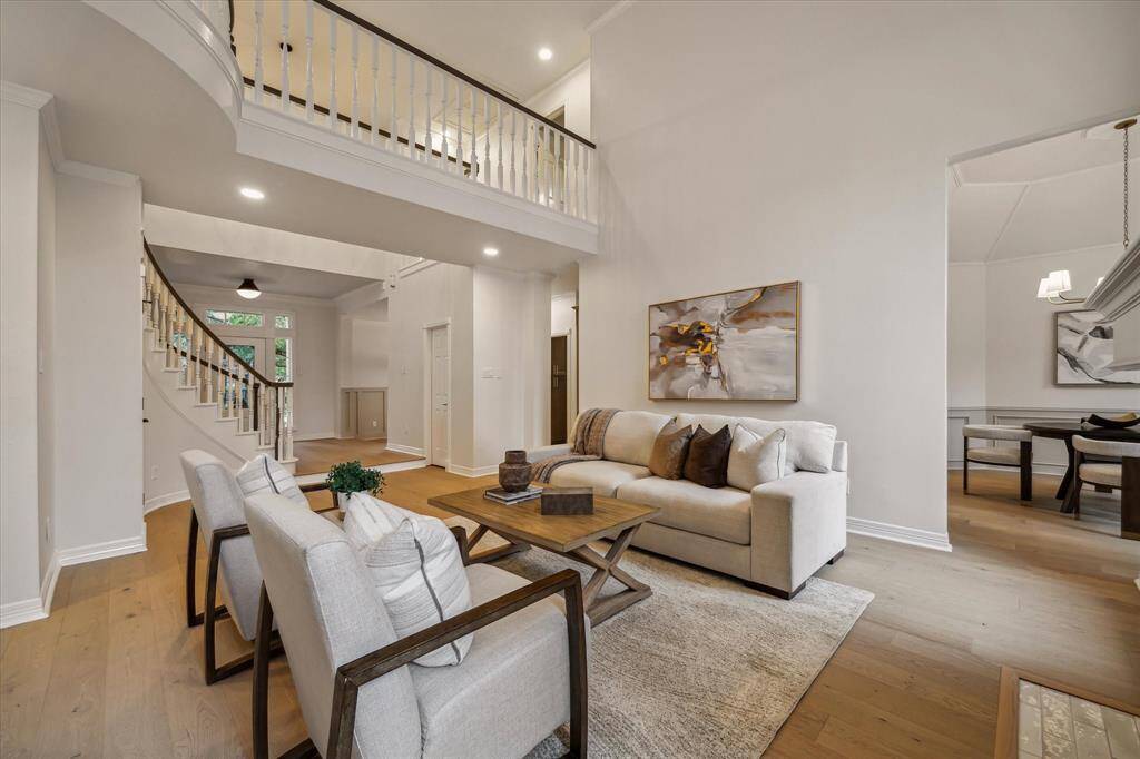 THE FAMILY ROOM ALSO FEATURES VIEWS OF THE DINING ROOM AND UPSTAIRS CAT WALK.