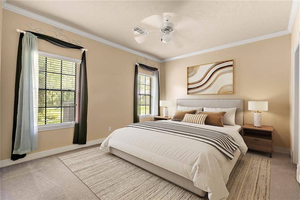 Another spacious secondary bedroom with soft carpeting, natural light, and a versatile layout.