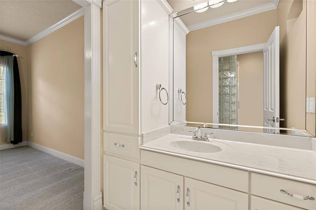 Private vanity with linen storage to secondary bedroom.