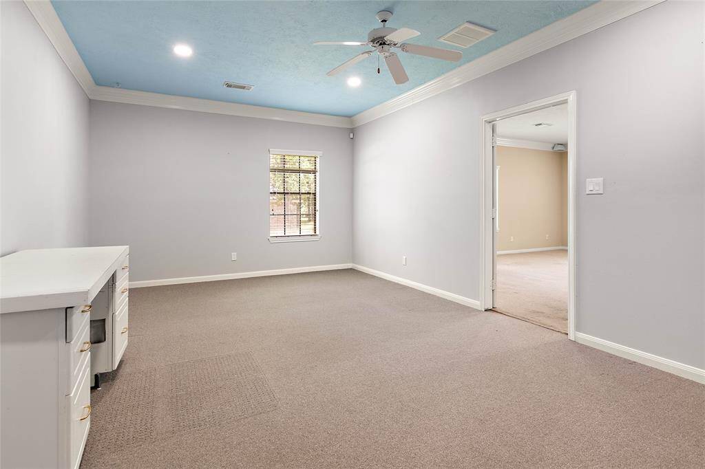 Charming flex space between the game room and garage features a built-in desk.  It was previously used as a large office, and is also ideal for crafting, homeschooling, or a quiet hobby room.