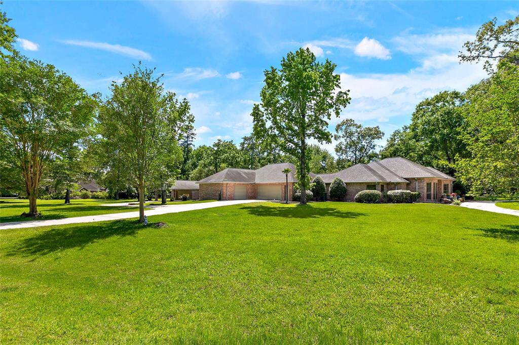 Spectacular view of the home and garages showcasing brick construction and architectural details.