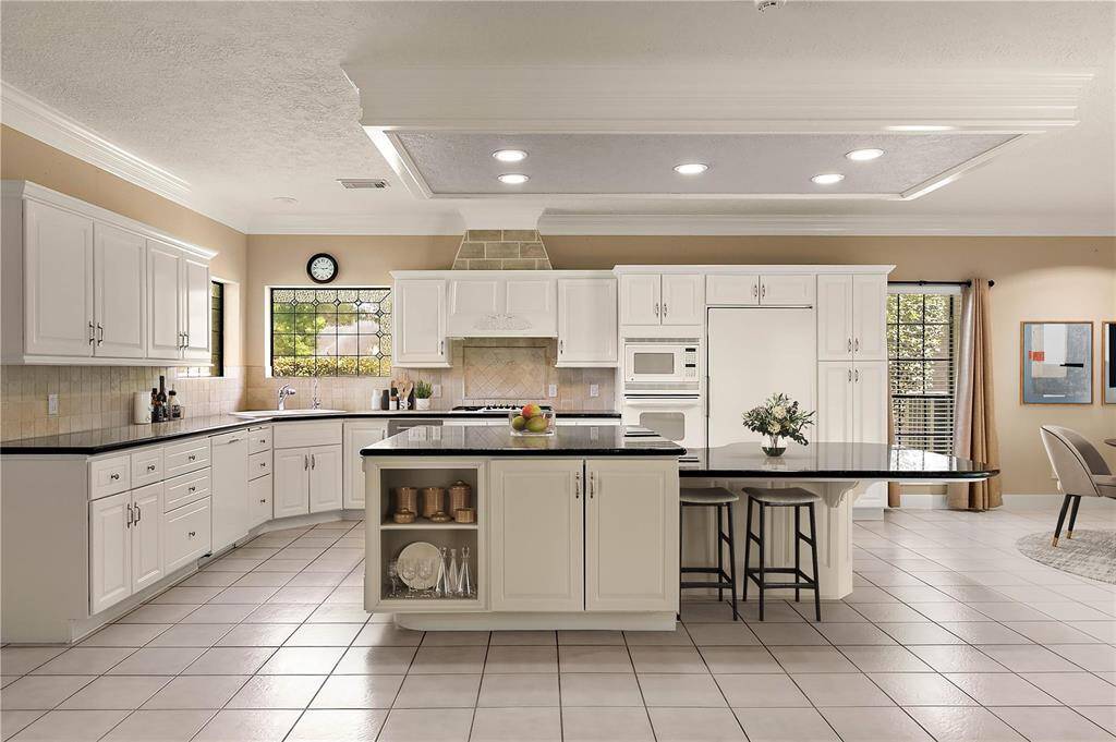 Gourmet kitchen with granite countertops and a spacious island with additional casual dining seating.
