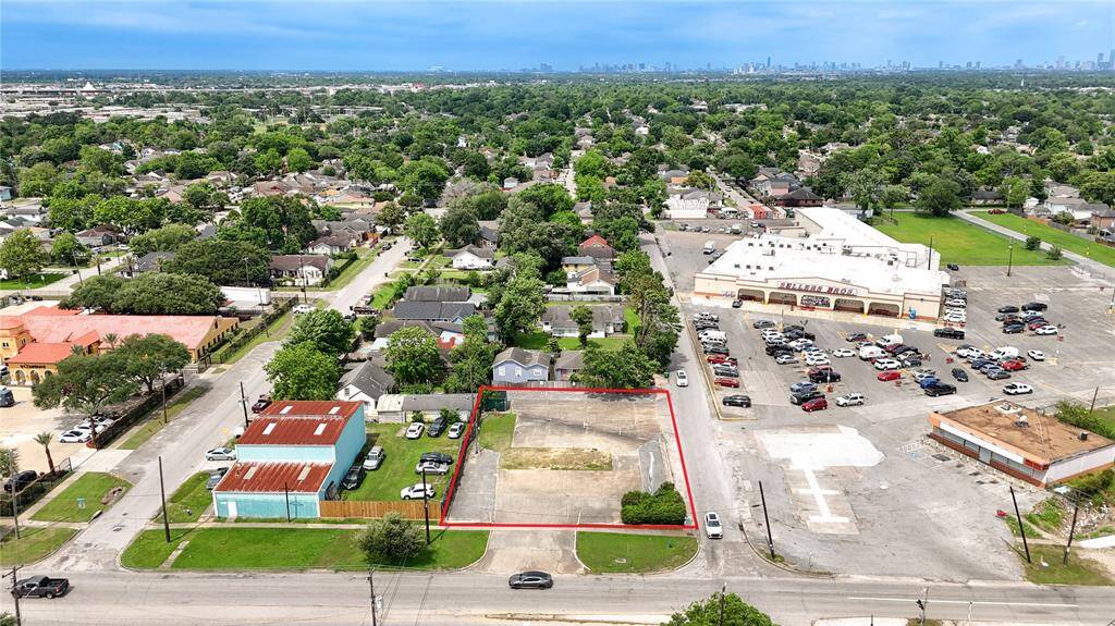 West view of Sellers Brothers Grocery & Houston skyline
