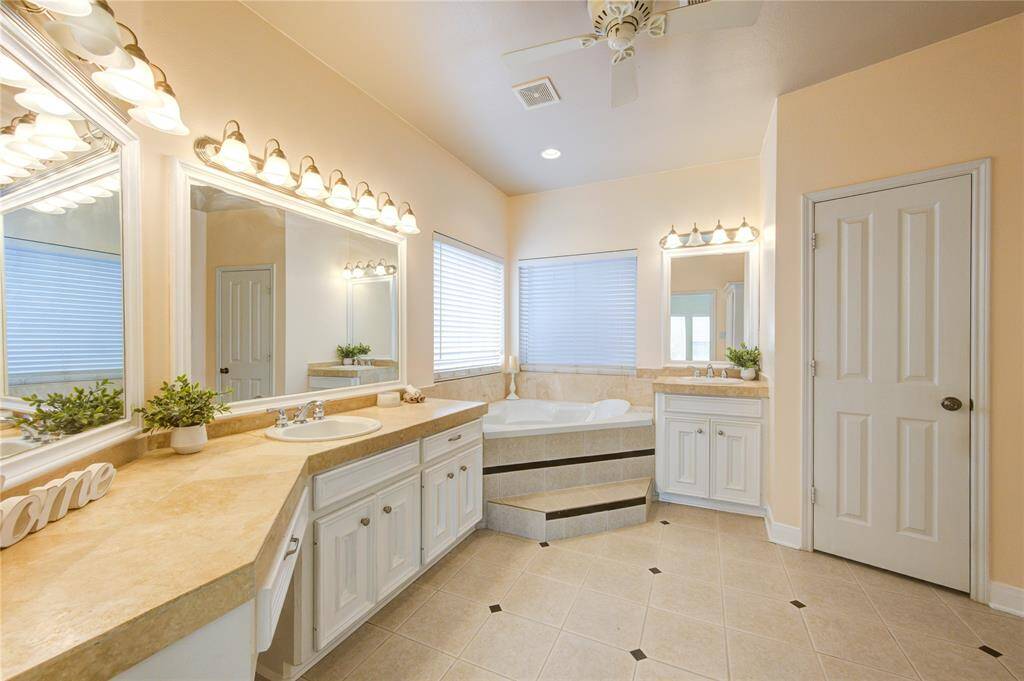 You don't have to share! The double sink vanity and oversized mirror lends itself to harmonious mornings.