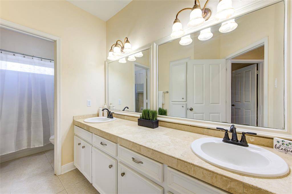 This clean and attractive space is perfect for family and guests alike. A large vanity provides room for all the essentials.