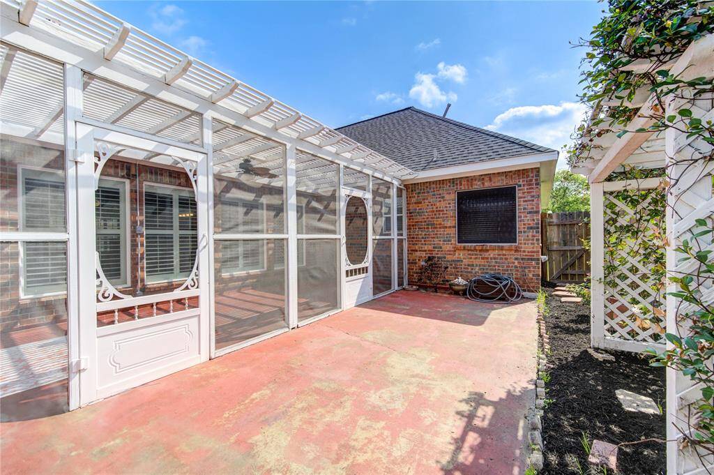 Fenced side patio offers a quiet, private space for relaxing or entertaining outdoors.