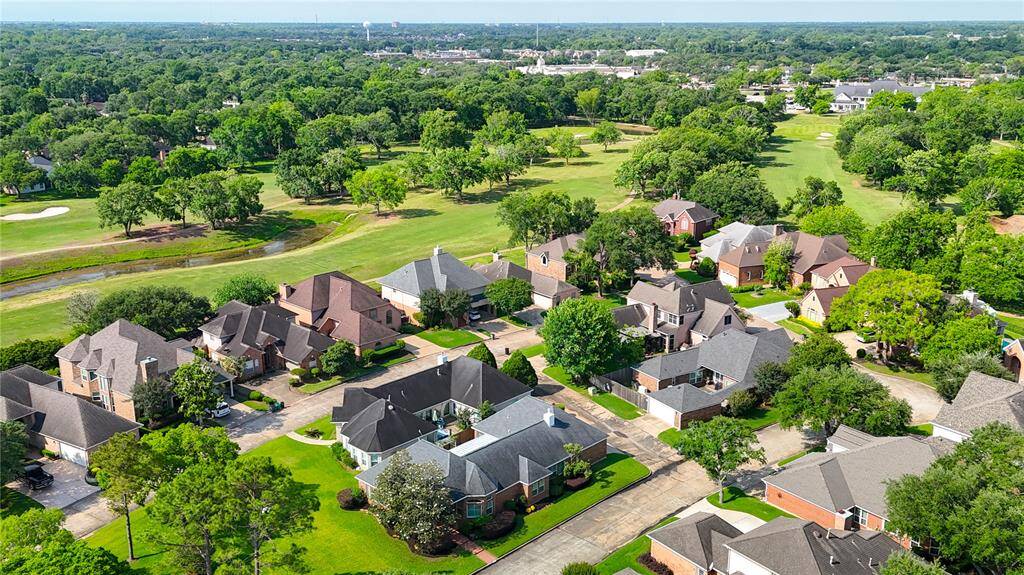 A stunning aerial view highlighting the picturesque golf course and The Club at Pecan Grove.
