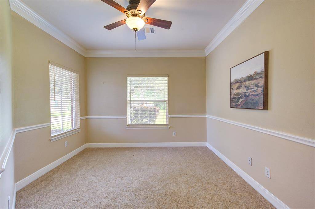 Bright home office with French doors and crown molding—perfect for work, study, or a quiet retreat