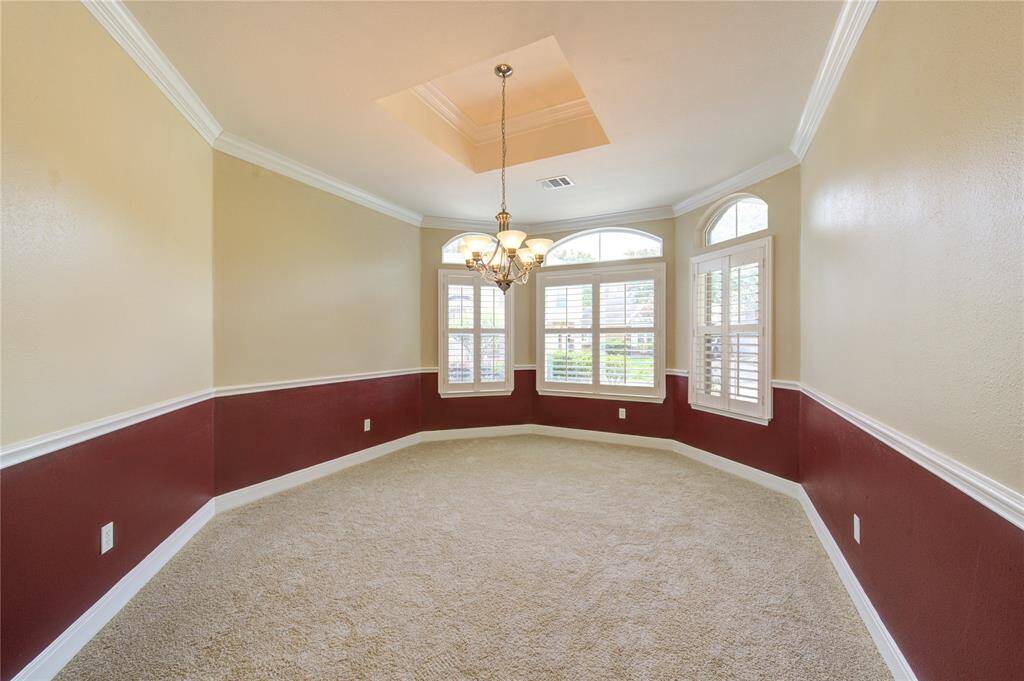 Dining room has crown molding, chair railing and a striking chandelier, you are sure to fall in love!