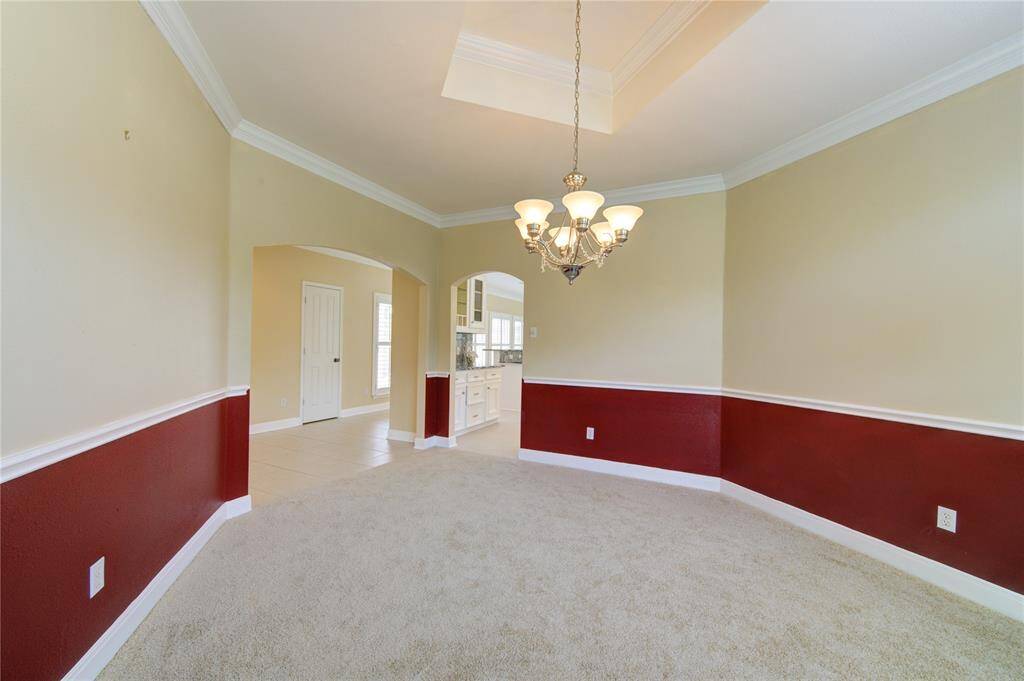 The dining room offers a welcoming space for gatherings, with seamless access to the kitchen for effortless entertaining.