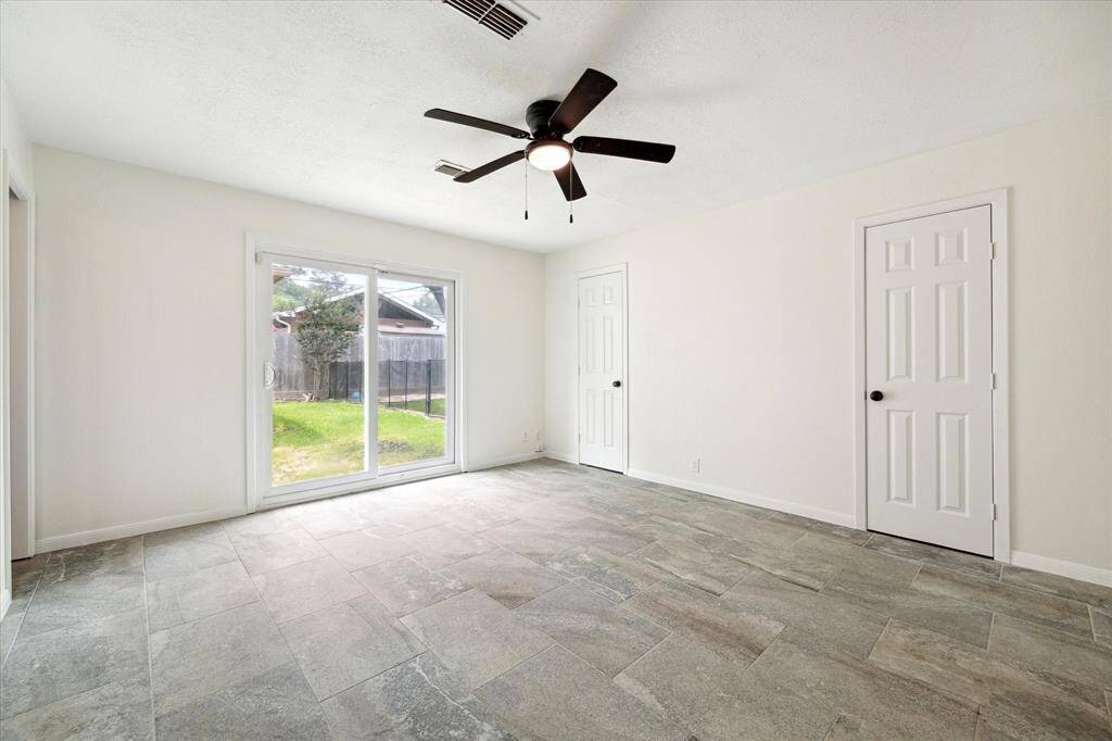 Primary bedroom with backyard views.