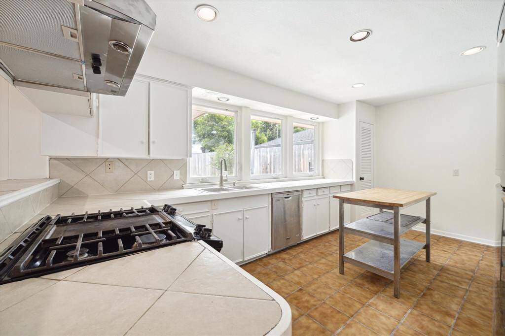 Kitchen with gas range and views of the pool.