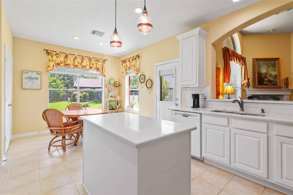 View from kitchen overlooking to the family room. There is an undermount sink and breakfast bar.