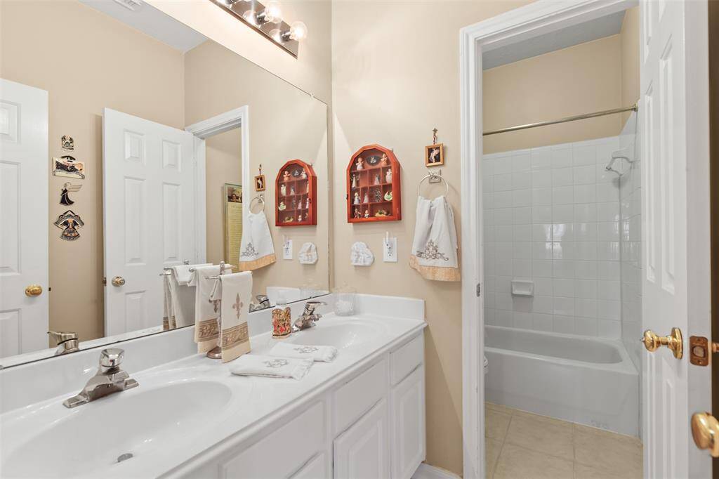 Secondary full bathroom features double sinks and a tub/shower combo.