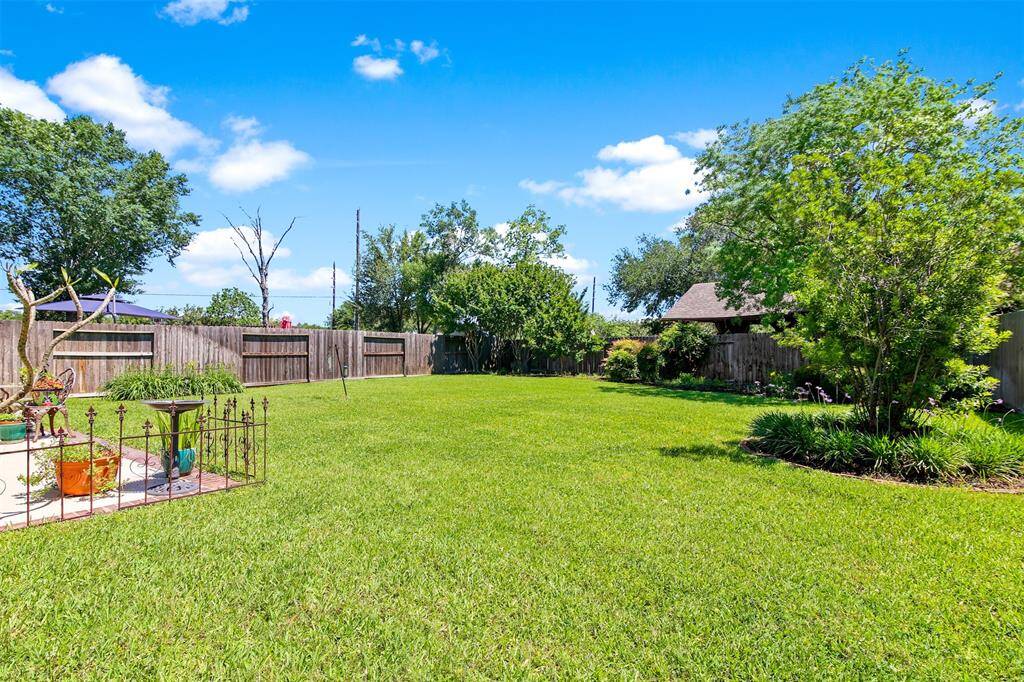 Backyard has mature trees and landscaping.