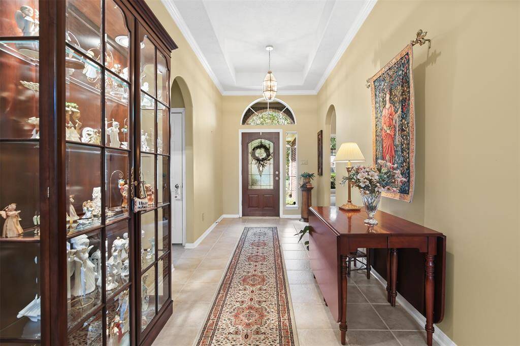 Front entry of home is spacious with tray ceiling and tile flooring.