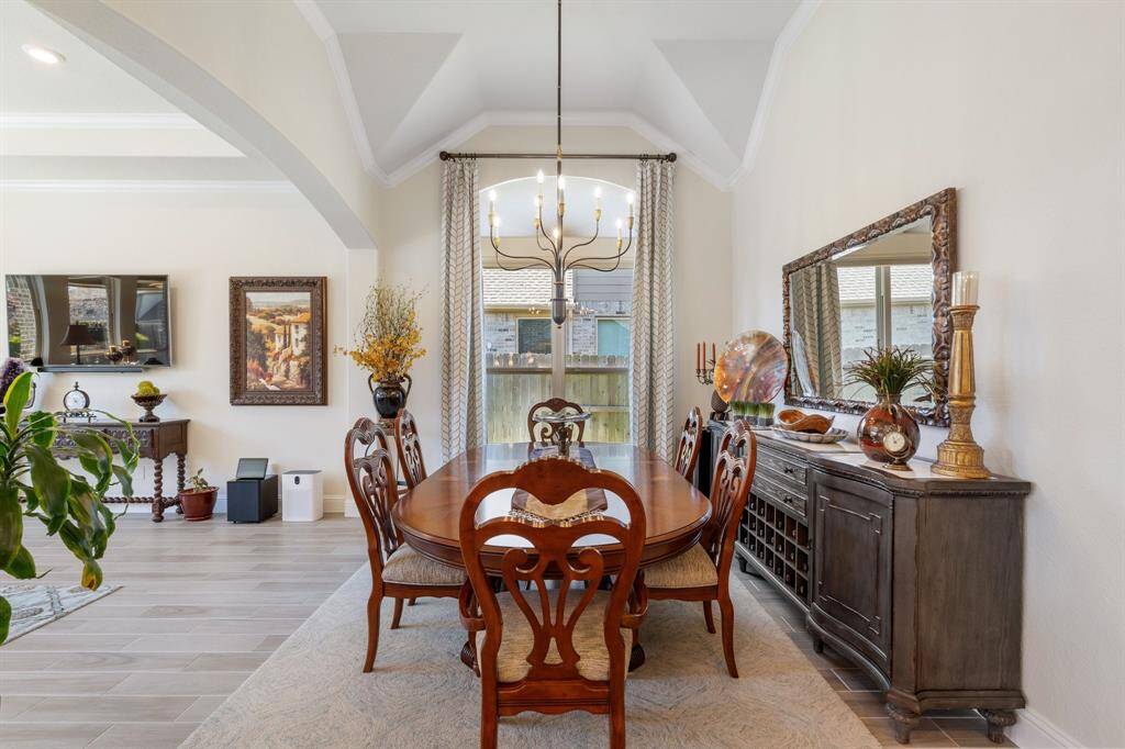 The first main area you come to from the foyer on your right is your formal dining room, which is open to the family room and kitchen. Notice the size of the dining room and the high ceilings.