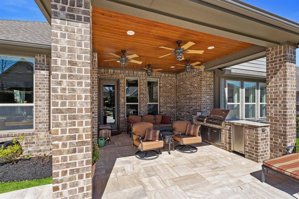 Outdoor cooking and grilling area, great sitting area, and 4 large fans for cooling. Back patio is partially covered/uncovered.