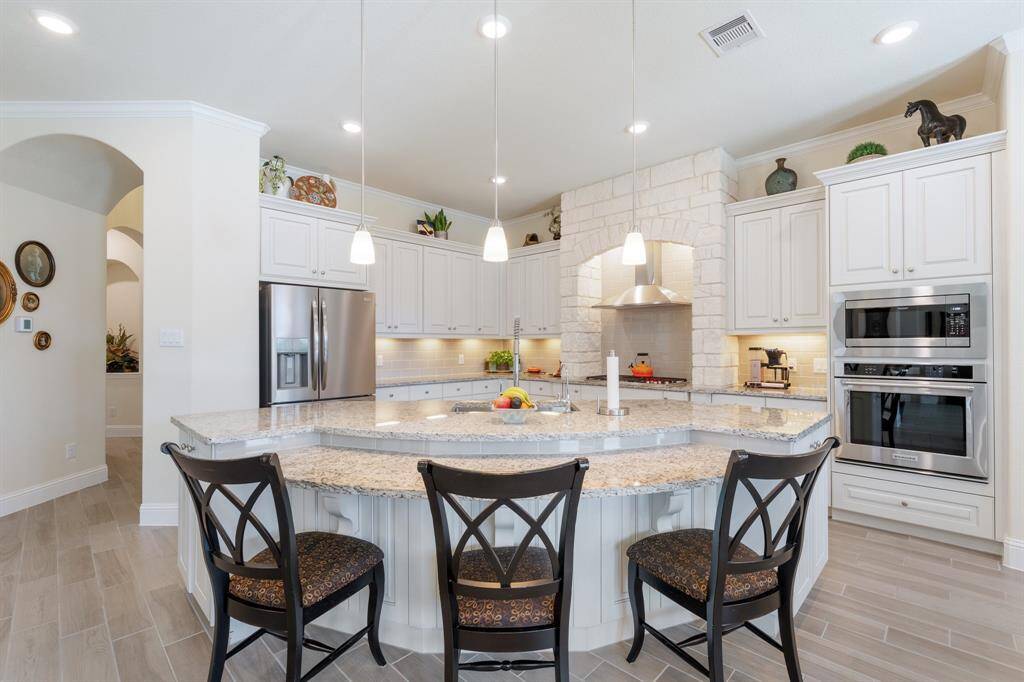 This amazing gourmet kitchen is ready for your cooking skills! This massive curved island is perfect for buffet style serving or as a breakfast bar.