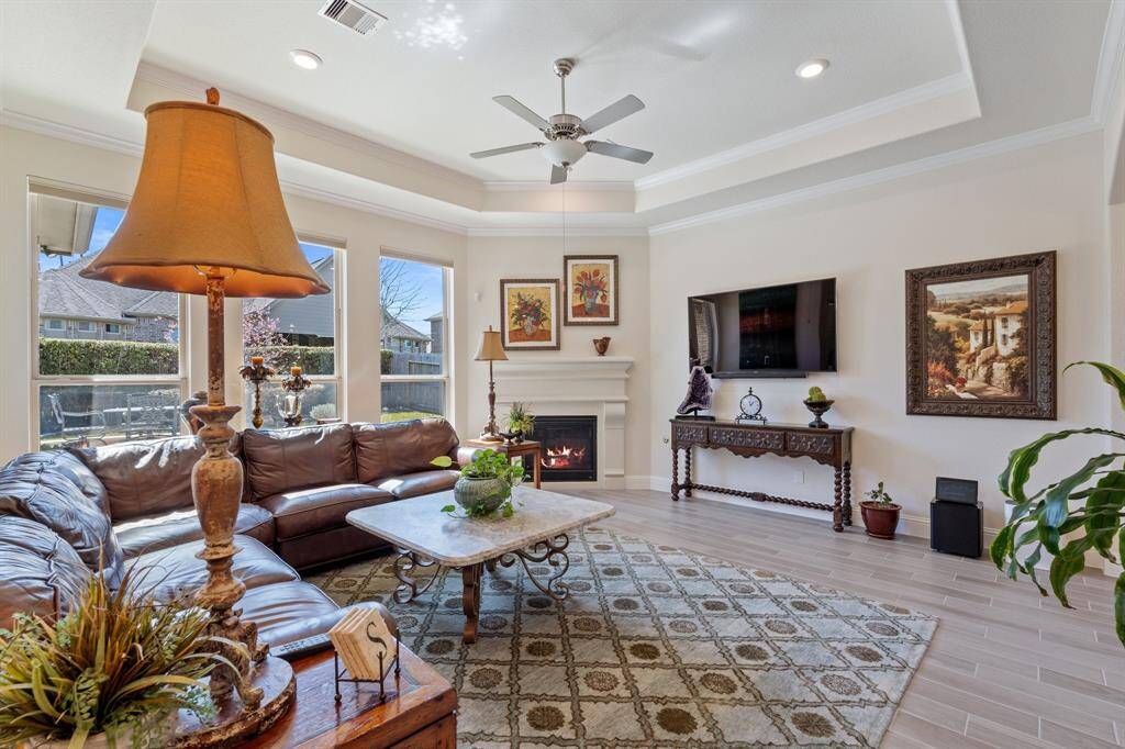 The large family room is the main gathering space. It's complete with large windows to let in natural light, trey ceilings, a cozy fireplace and beautiful flooring.