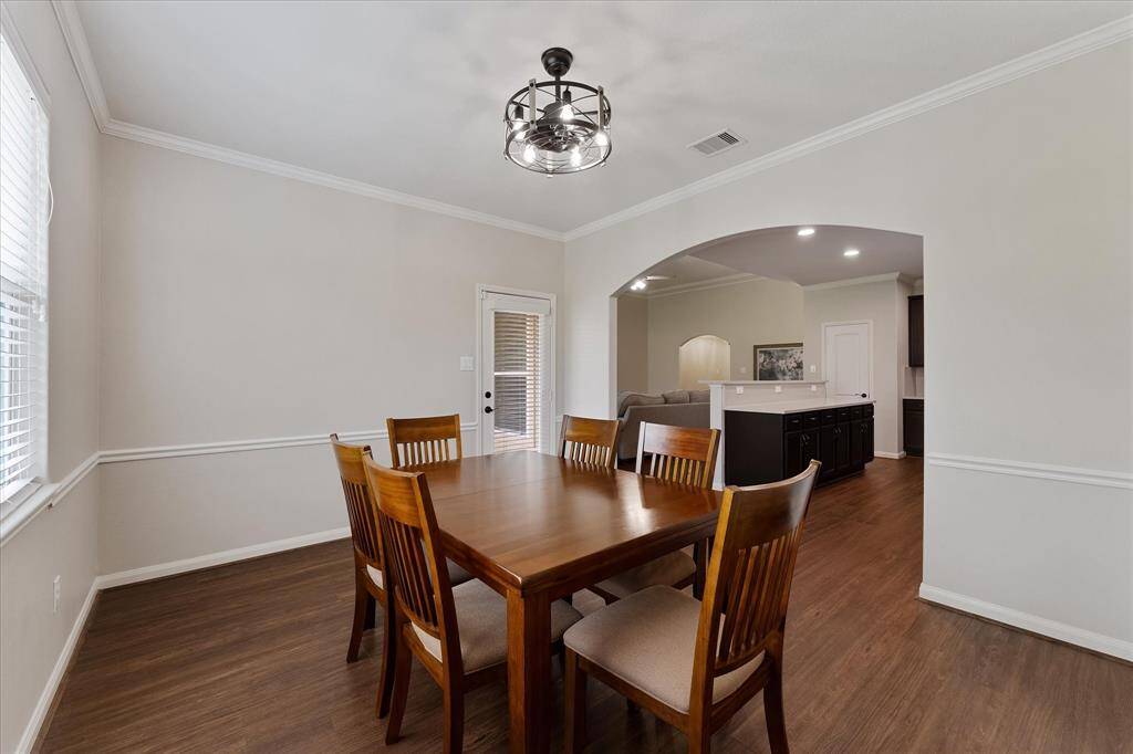 Dining/breakfast room with custom moldings and views to the backyard