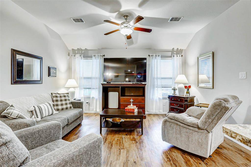 The spacious family room is bright and inviting, with large windows that flood the space with natural light and highlight the open, airy layout.