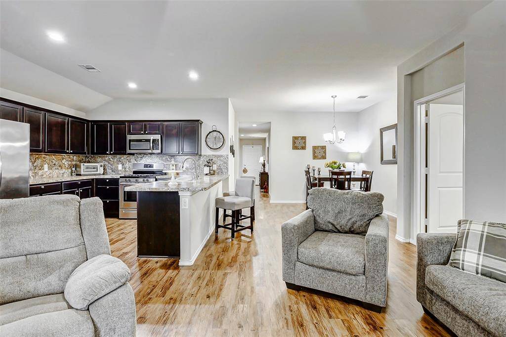 The open floor plan creates a seamless flow to the kitchen and dining areas, perfect for both everyday living and entertaining.