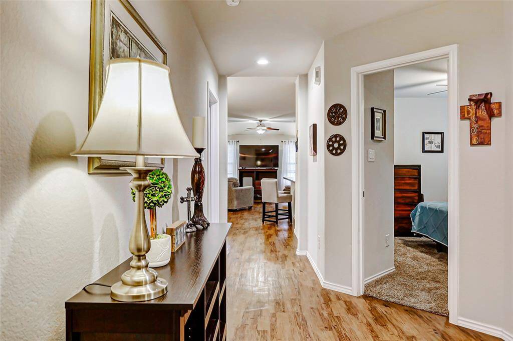 Step through the welcoming front door into a bright interior that immediately feels like home. Gleaming vinyl plank flooring stretches throughout the main living areas, while soaring ceilings create an airy atmosphere.