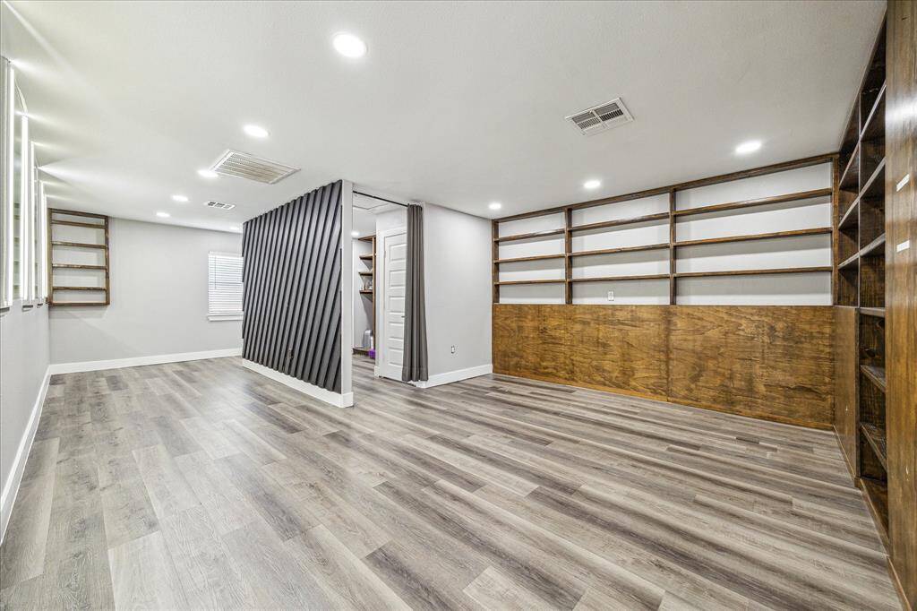Built-in shelves accented by recessed lighting and classic baseboards.