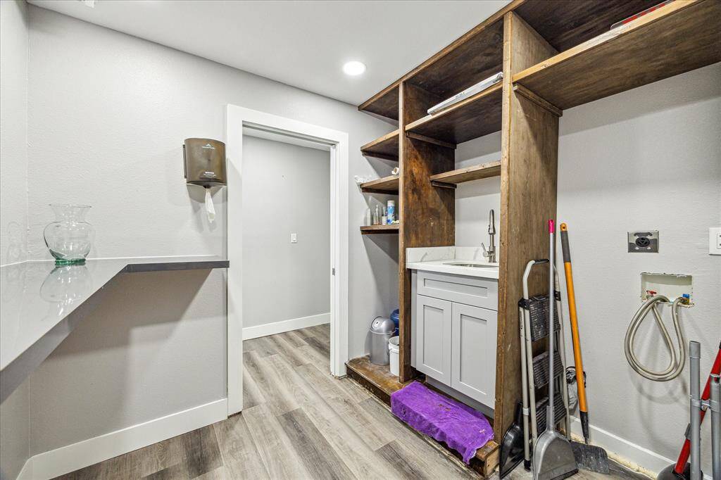 Clean utility room with practical wall shelves and natural light.