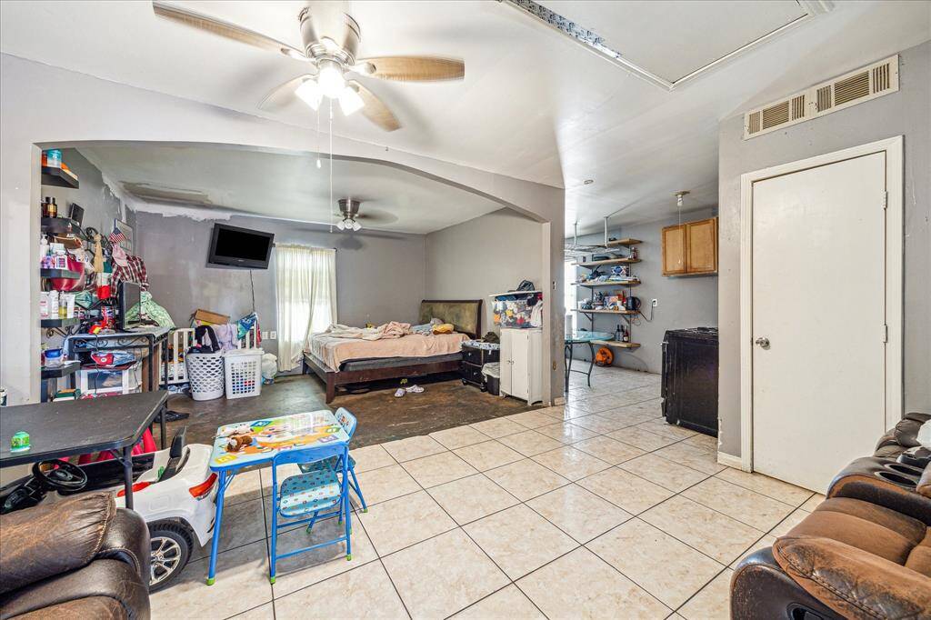 Spacious area with ceiling fans, bright ambiance, and natural light.