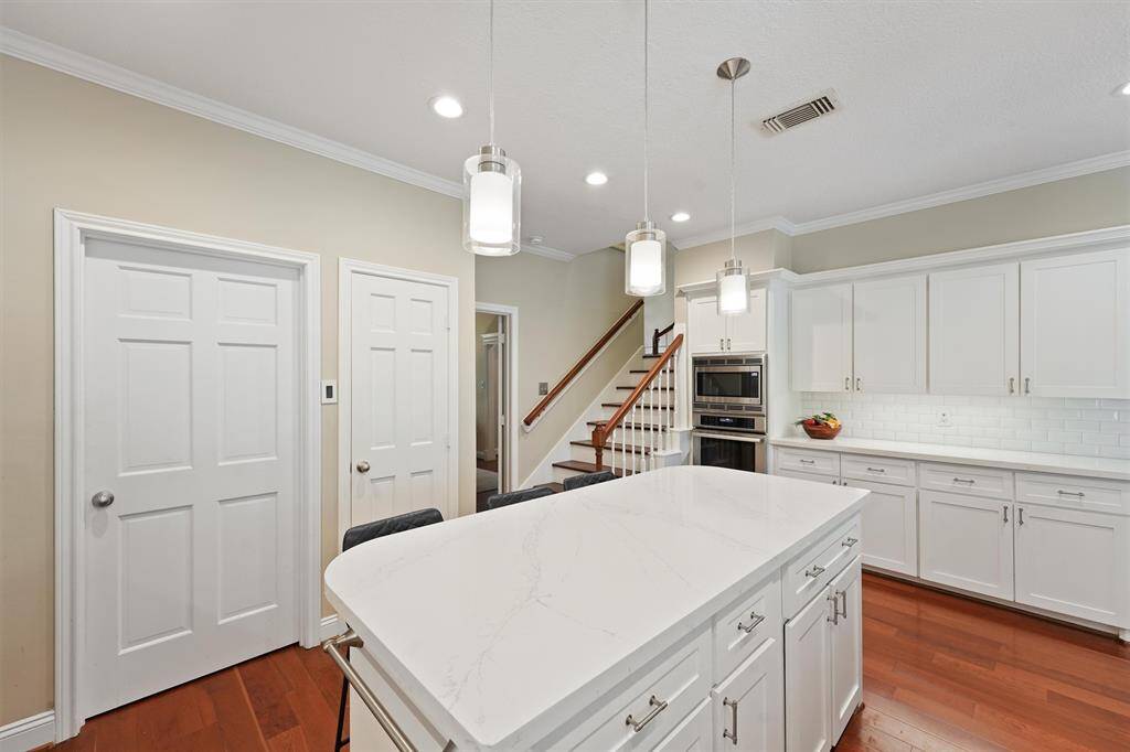 This kitchen has a gas range and an additional electric oven and microwave-all Thermador. A second staircase for easy access to the second floor.