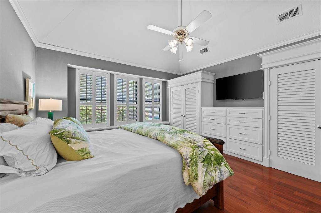 Built-in closets and dresser in primary bedroom.
