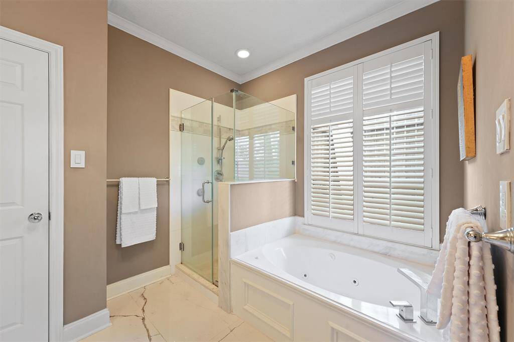 Seamless shower, a tub for soaking and shutters for privacy.