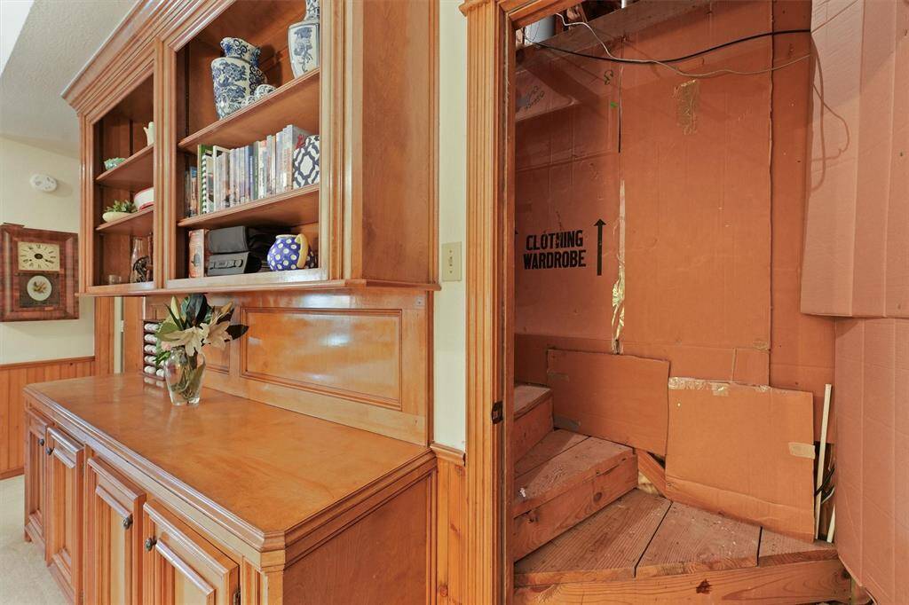 Hard staircase off the game room leading to the attic and storage area,