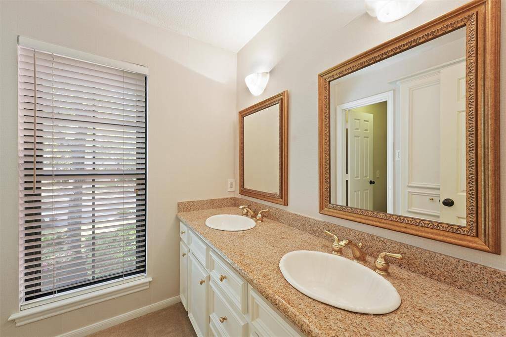 Upstairs full bath with double sinks.