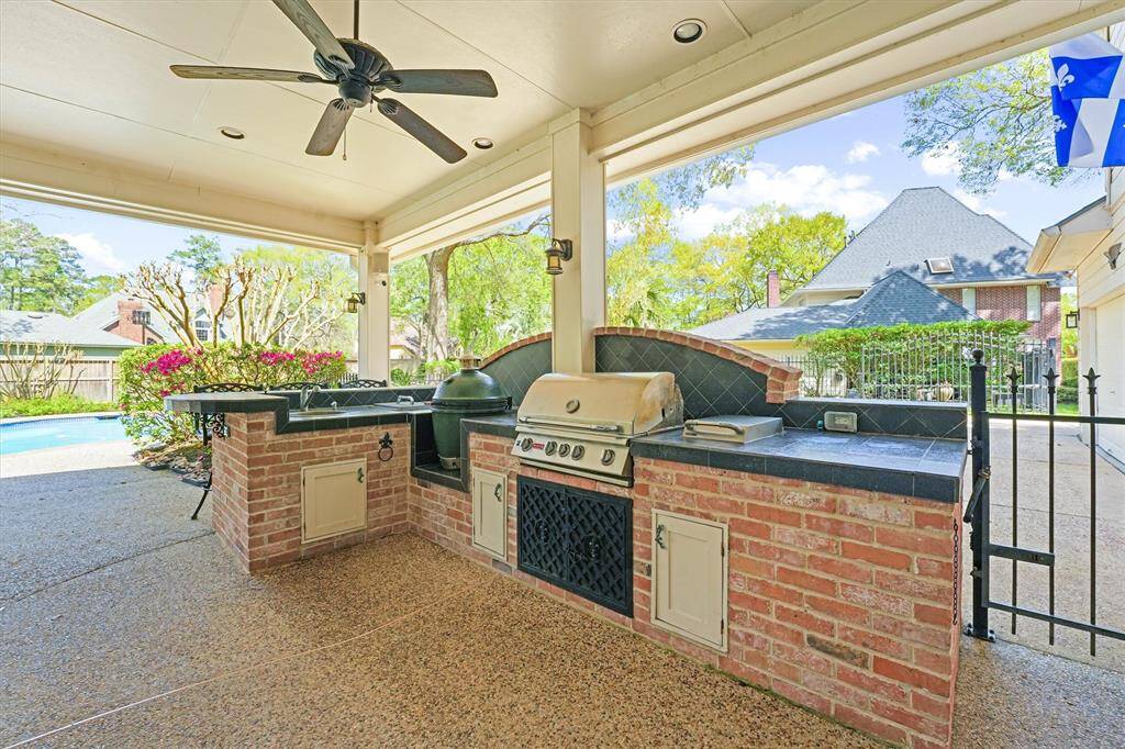 Outdoor Kitchen with H/C water, stainless sink, Bull 4 burner gas grill, side burner and ice chest.