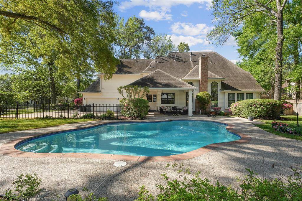 Three car garage, pool. patio and privacy!
