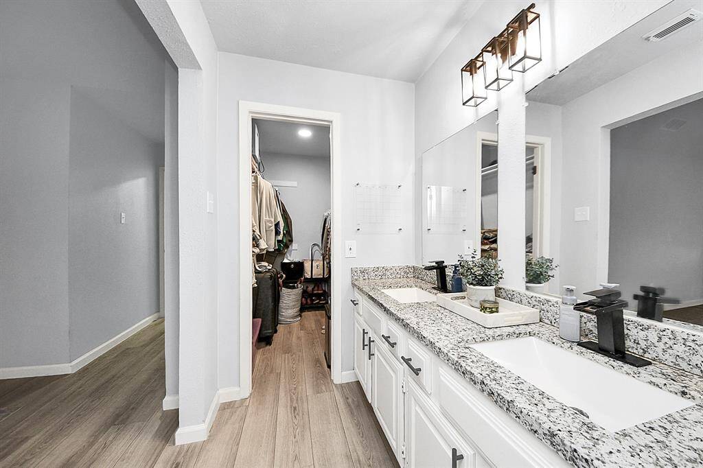 Double vanity and walk-in closet area for primary bath.