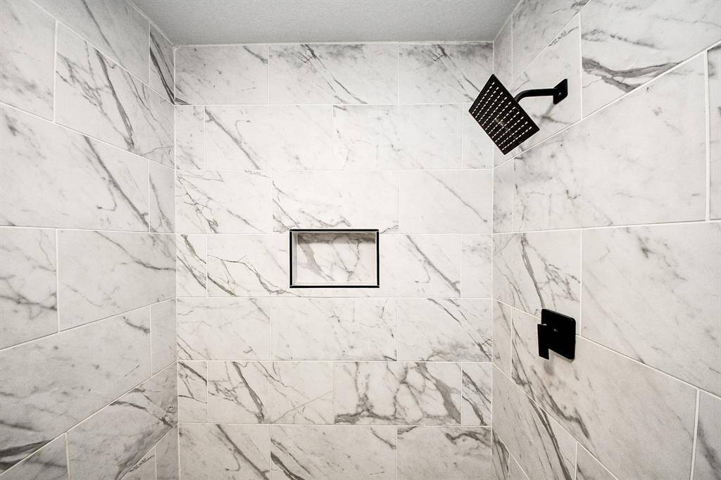 Primary bath with large shower and beautifully updated tile.