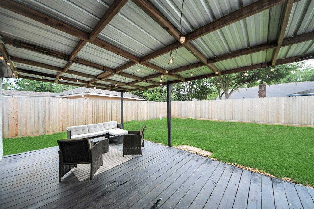 Covered back patio. Notice the new fence.