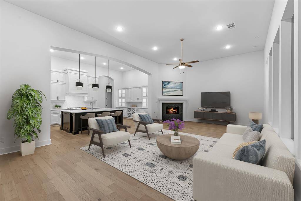 Virtually staged to show furniture placement, the family room is the heart and center of the home with a tile gas fireplace and views of the backyard.