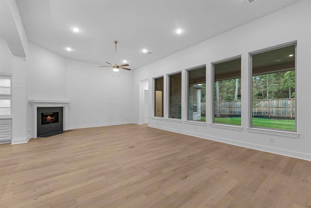 Additional view of the family room with tile accented gas fireplace.