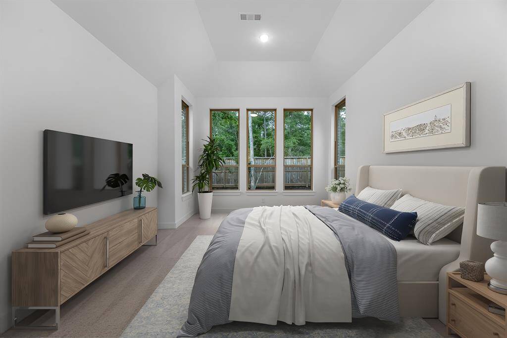 The primary retreat, virtually staged to show furniture placement, includes a sitting area and soaring ceilings.