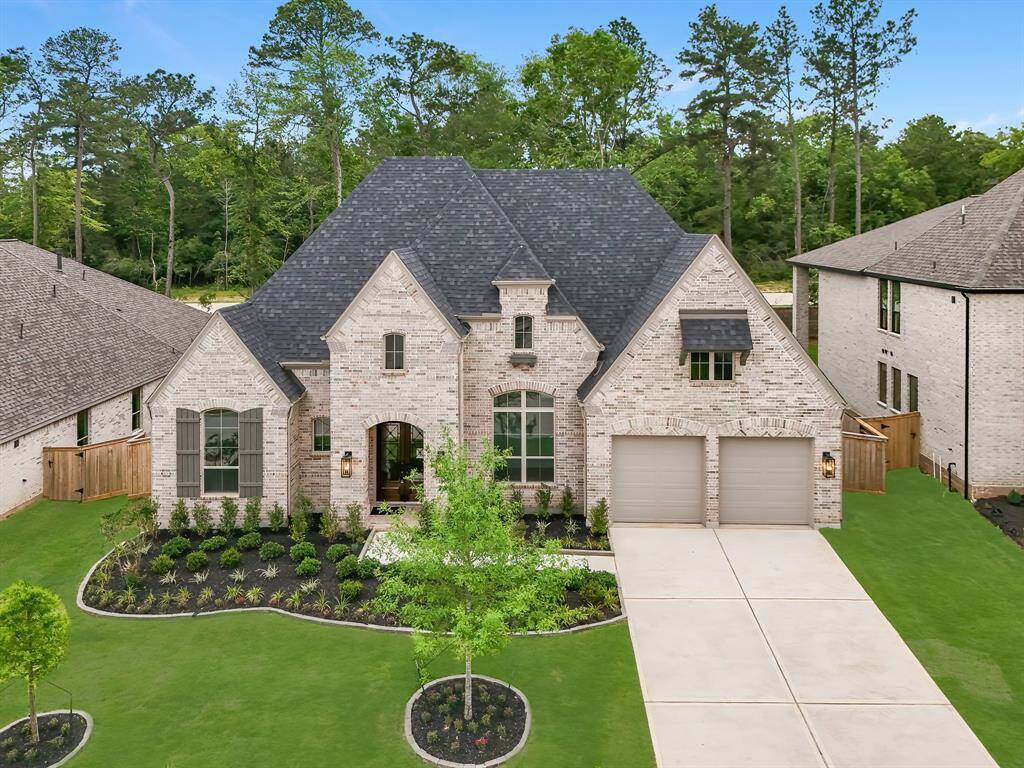 Professional landscaping and classic curb appeal on this newly constructed Highland Home.