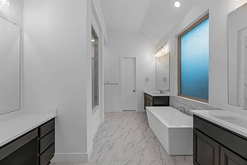 The primary bathroom also includes a useful vanity area separate from the double sinks.