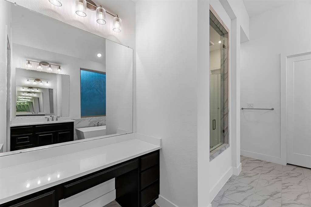 Additional view of the vanity area in the primary bathroom.