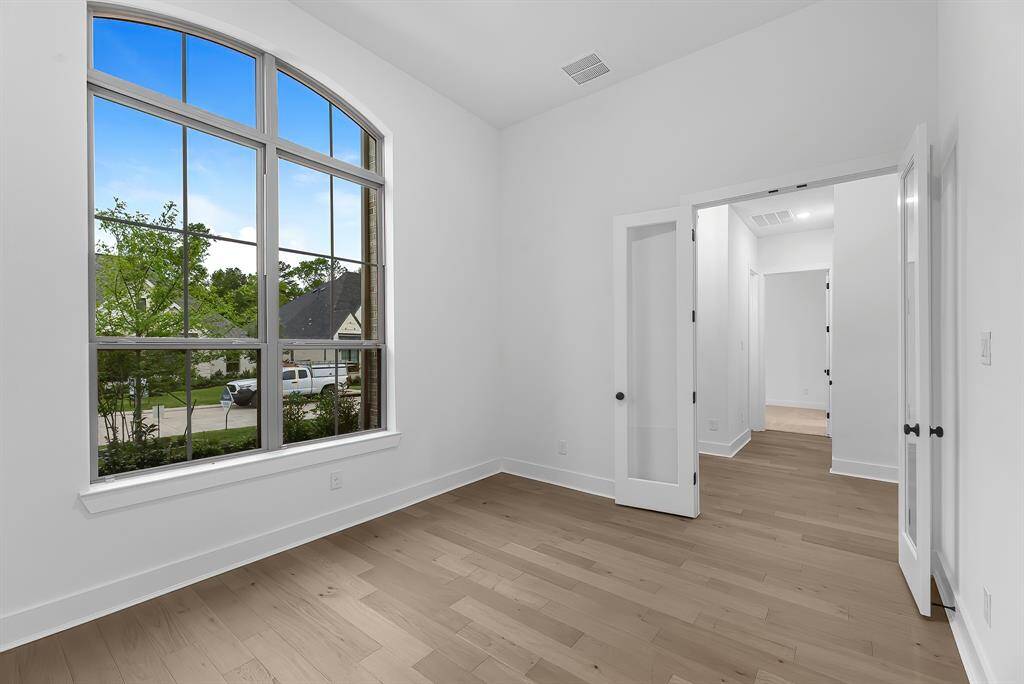 The private home office is located at the front of the home and features double French doors.