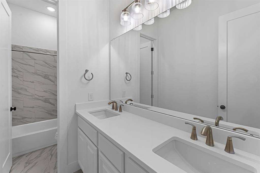 Bathroom #3 with double sinks and tub/shower combo.
