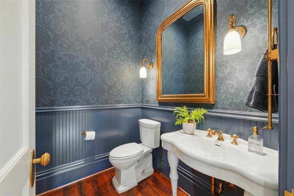 Even the powder room is dressed to impress. With Thibaut wallpaper, gilded accents and elegant finishes, it reflects the home’s refined style down to the smallest detail.